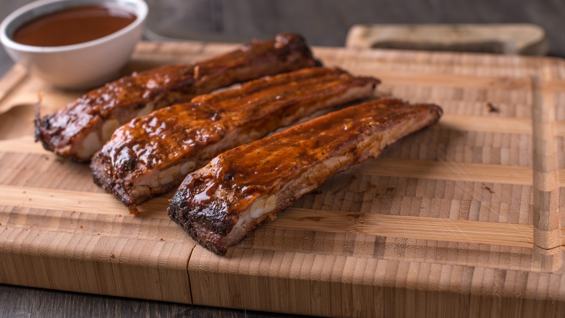 RIbs on a cutting board with BBQ sauce